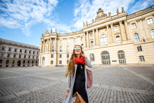 Young woman student walking near the old library in Berlin city