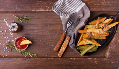 French fries with ketchup on wooden background. Top view