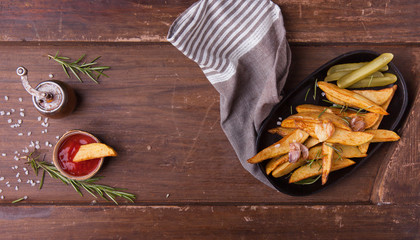 French fries with ketchup on wooden background. Top view