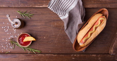 Fast food, hot dog with yellow mustard and french fries. Top view