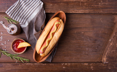 Fast food, hot dog with yellow mustard and french fries. Top view