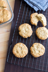 Gluten free homemade oatmeal cookies and napkin on cooling rack. Vertical