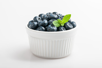 Blueberries in bowl on white background