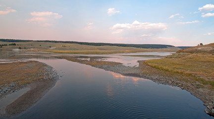 Sunset at confluence of Elk Anter Creek and Yellowstone River in the Hayden Valley in Yellowstone National Park in Wyoming USA