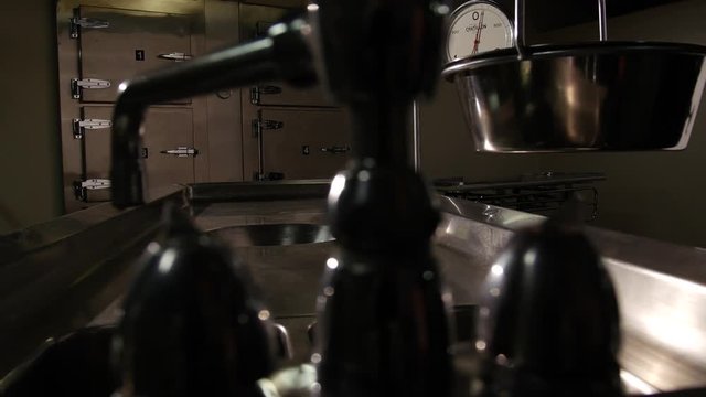 AUTOPSY TABLE HAS A LEAKY FAUCET.  SLOW DOLLY MOVE.