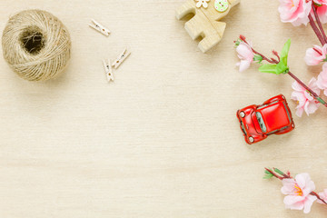 Top view car house rope and flower on wooden background.