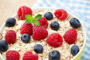 Oatmeal porridge with berries. Raspberries and blueberries.
