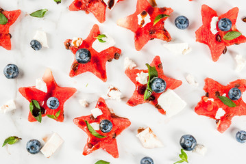 Summer fruit berry salad: watermelon sliced in the form of stars, blueberries, feta cheese and...