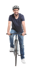 Handsome young man riding bicycle on white background