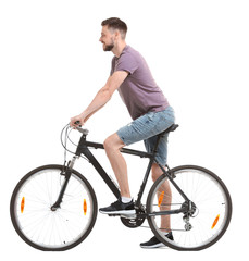 Obraz premium Handsome young man riding bicycle on white background