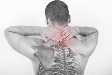 Rear view of a young man holding his neck in pain, isolated on white background. Lower neck pain. Shirtless man touching his neck for the pain.