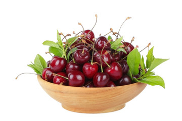 cherry with leaves in wooden plate isolated