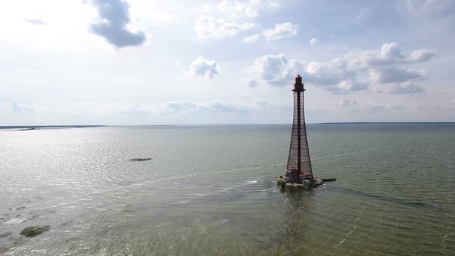 Amazing bird`s eye shot of a metal frame light house near Dzharylhach island, its shoal in the Black sea from a low flying drone. The seascape looks great and gorgeous