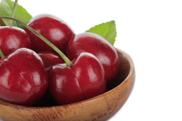 cherry in wooden bowl isolated