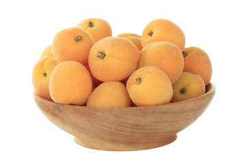 heap of apricots in wooden plate isolated