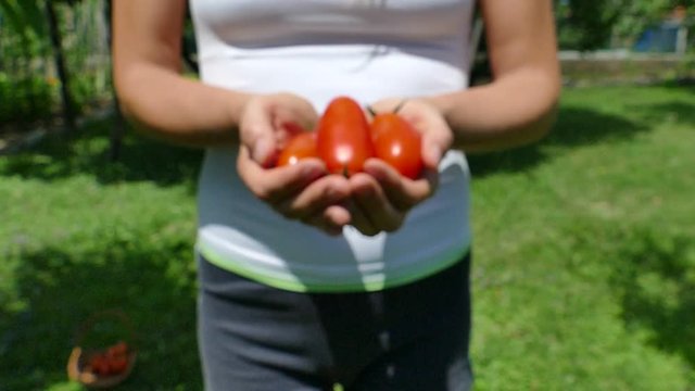 Stretching hands with pelati tomatoes, selective focus, slow motion, FHD