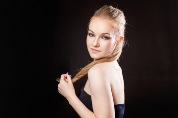 Obraz premium Beautiful blonde girl on a black background