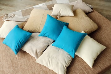 Colorful pillows on the bed are warm and cozy 