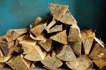 Brown firewood for the fireplace on a blue background 