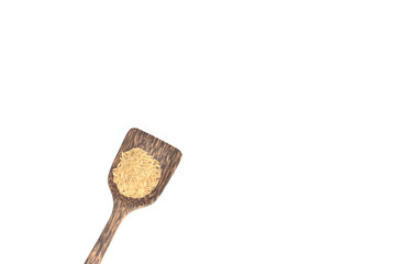Grains in a wooden spoon on a white background.