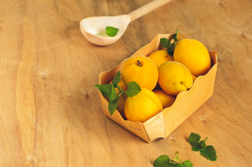 Ripe apricots in a wooden box