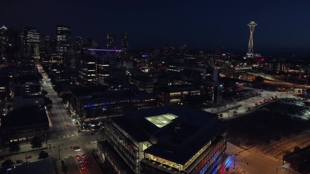 Aerial of Downtown Seattle Lit at Night with Cars Driving on City Streets