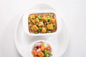 Cheese Cooked with Peas in a Creamy Sauce