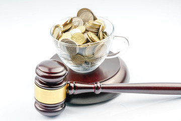 Wood gavel and coins with white background.