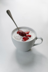 Ice cream with strawberries in a cup on the table