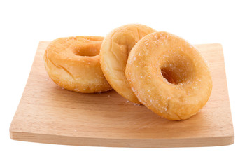Sugary donuts on a wooden plate isolated on a white background