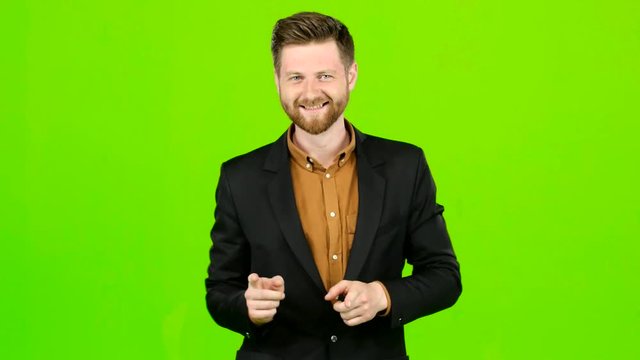 Male actor smiles, showing them different grimaces and language. Green screen