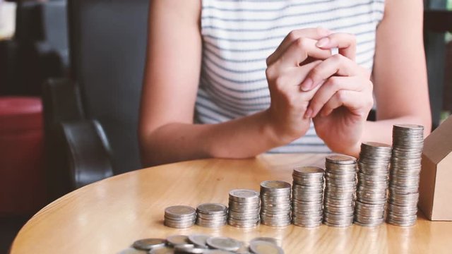 business people  finances  money saving and economy concept - close up of girl hands putting money coins into columns