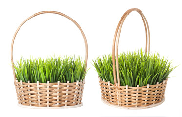 Grass in wicker basket isolated on white background