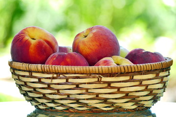 Organic peaches in basket. Fresh peaches in nature.