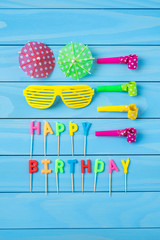 Birthday accessories on blue wooden table