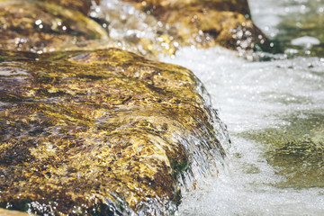 Small waterfall in a torrent, with shallow depth of field