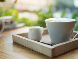 cup of coffee on wood table in coffee cafe