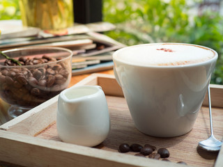 Hot coffee cup in coffee shop morning light