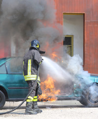 car with flames and black smoke firefighter intervening to tampe