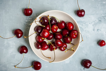 Fototapeta na wymiar Fresh cherries in bowl on the wooden background