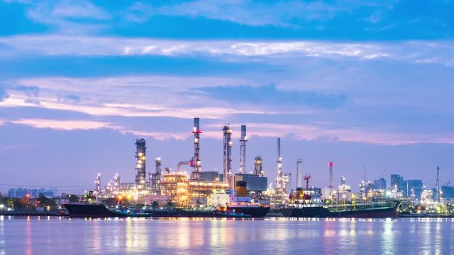 Twilight scene of oil refinery plant and cargo shipping.