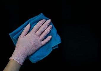 Woman doing cleaning in the room with gloves on a black background. isolate