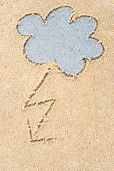stormy clouds drawing in sand