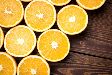 Half cut oranges on an old wooden table