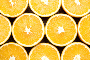 Half cut oranges on an old wooden table