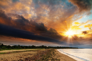 The coastline of Maroantsetra in Madagascar at sunrise, with a dramatic sky