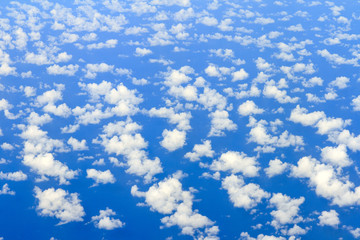 Fototapeta na wymiar Aerial view on some clouds in the sky above the ocean seen from above 