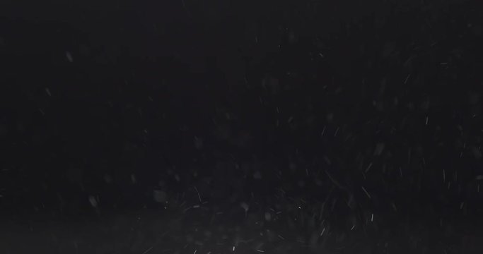 slow motion macro shot of dust particles explosion over black background