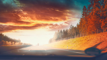 Plakat Highway road in autumnal landscape with Beautiful sky and sunlight, fall travel concept