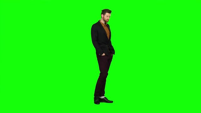 Guy flirts, he smiles and builds his eyes. Green screen